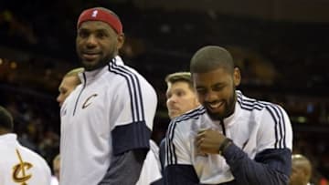 Oct 14, 2014; Cleveland, OH, USA; Cleveland Cavaliers forward LeBron James (left) and guard Kyrie Irving (2) smile in the third quarter against the Milwaukee Bucks at Quicken Loans Arena. Mandatory Credit: David Richard-USA TODAY Sports
