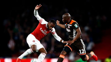 LONDON, ENGLAND - SEPTEMBER 26: Alexandre Lacazette of Arsenal is challenged by Kamo Mokotjo of Brentford during the Carabao Cup Third Round match between Arsenal and Brentford at Emirates Stadium on September 26, 2018 in London, England. (Photo by Julian Finney/Getty Images)