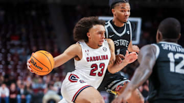 Nov 9, 2021; Columbia, South Carolina, USA; South Carolina Gamecocks guard Devin Carter (23) drives around South Carolina Upstate Spartans guard/forward Quentin Hodge (1) in the first half at Colonial Life Arena. Mandatory Credit: Jeff Blake-USA TODAY Sports