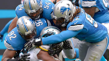 CHARLOTTE, NC - SEPTEMBER 14: Ezekiel Ansah #94, DeAndre Levy #54 and Darryl Tapp #52 of the Detroit Lions tackle Jonathan Stewart #28 of the Carolina Panthers during their game at Bank of America Stadium on September 14, 2014 in Charlotte, North Carolina. The Panthers won 24-7. (Photo by Grant Halverson/Getty Images)