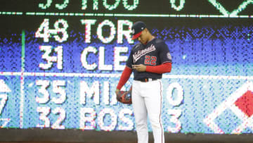 May 29, 2021; Washington, District of Columbia, USA; Washington Nationals left fielder Juan Soto (22) looks at a piece of paper on the field against the Milwaukee Brewers during the first inning at Nationals Park. Mandatory Credit: Amber Searls-USA TODAY Sports