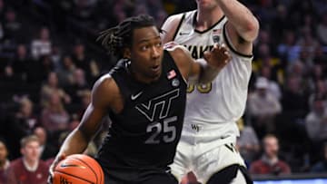 Dec 31, 2022; Winston-Salem, North Carolina, USA; Virginia Tech Hokies forward Justyn Mutts (25) drives the baseline againstWake Forest Demon Deacons forward Matthew Marsh (33) during the second half at Lawrence Joel Veterans Memorial Coliseum. Mandatory Credit: William Howard-USA TODAY Sports