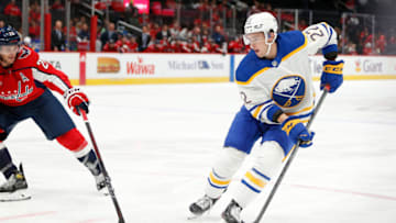 Sep 25, 2022; Washington, District of Columbia, USA; Buffalo Sabres right wing Jack Quinn (22) skates with the puck as Washington Capitals center Nic Dowd (26) defends during the second period at Capital One Arena. Mandatory Credit: Amber Searls-USA TODAY Sports