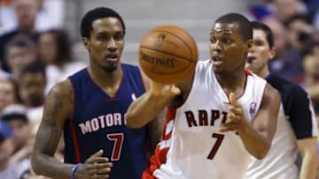 Apr 13, 2014; Auburn Hills, MI, USA; Toronto Raptors guard Kyle Lowry (7) passes the ball away from Detroit Pistons guard Brandon Jennings (7) in the second half at The Palace of Auburn Hills. Mandatory Credit: Rick Osentoski-USA TODAY Sports