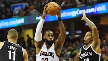 Dec 23, 2016; Cleveland, OH, USA; Cleveland Cavaliers forward LeBron James (23) drives to the basket between Brooklyn Nets center Brook Lopez (11) and forward Rondae Hollis-Jefferson (24) during the first half at Quicken Loans Arena. Mandatory Credit: Ken Blaze-USA TODAY Sports