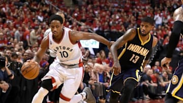 May 1, 2016; Toronto, Ontario, CAN; Toronto Raptors guard DeMar DeRozan (10) dribbles away from Indiana Pacers forward Paul George (13) in game seven of the first round of the 2016 NBA Playoffs at Air Canada Centre. Mandatory Credit: Dan Hamilton-USA TODAY Sports