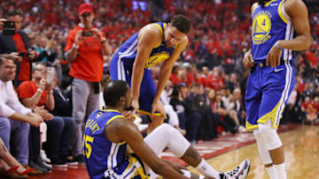 TORONTO, ONTARIO - JUNE 10: Klay Thompson #11 of the Golden State Warriors helps Kevin Durant #35 to his feet in the first half against the Toronto Raptors during Game Five of the 2019 NBA Finals at Scotiabank Arena on June 10, 2019 in Toronto, Canada. NOTE TO USER: User expressly acknowledges and agrees that, by downloading and or using this photograph, User is consenting to the terms and conditions of the Getty Images License Agreement. (Photo by Gregory Shamus/Getty Images)