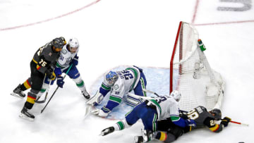 EDMONTON, ALBERTA - SEPTEMBER 01: Alexander Edler #23 of the Vancouver Canucks checks William Carrier #28 of the Vegas Golden Knights as Thatcher Demko #35 covers up the puck during the third period in Game Five of the Western Conference Second Round during the 2020 NHL Stanley Cup Playoffs at Rogers Place on September 01, 2020 in Edmonton, Alberta, Canada. (Photo by Bruce Bennett/Getty Images)