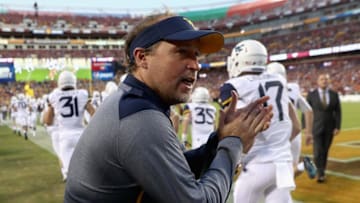 LANDOVER, MD - SEPTEMBER 03: Head coach Dana Holgorsen of the West Virginia Mountaineers watches as his team takes the field before the start of their game against the Virginia Tech Hokies at FedExField on September 3, 2017 in Landover, Maryland. (Photo by Rob Carr/Getty Images)