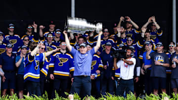 ST. LOUIS, MO - JUNE 15: St. Louis Blues' Interim Head Coach Craig Berube, center, hoists the Stanley Cup in front of his team and fans during the St. Louis Blues Victory Pep Rally on June 15, 2019, in Downtown St. Louis, MO. (Photo by Tim Spyers/Icon Sportswire via Getty Images)