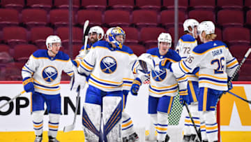 MONTREAL, QC - FEBRUARY 13: Goaltender Craig Anderson #41 and Rasmus Dahlin #26 of the Buffalo Sabres celebrate their victory against the Montreal Canadiens at Centre Bell on February 13, 2022 in Montreal, Canada. The Buffalo Sabres defeated the Montreal Canadiens 5-3. (Photo by Minas Panagiotakis/Getty Images)