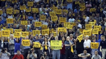 Apr 26, 2014; Memphis, TN, USA; Memphis Grizzlies fans hold up towels and signs during game four of the first round of the 2014 NBA Playoffs against the Oklahoma City Thunder at FedExForum. Thunder defeated the Grizzlies 92-89. Mandatory Credit: Nelson Chenault-USA TODAY Sports