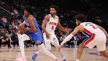 Jalen Williams #8 of the Oklahoma City Thunder drives between Braxton Key #8 and Cade Cunningham #2 of the Detroit Pistons during the first half at Little Caesars Arena on October 11, 2022 in Detroit, Michigan. (Photo by Gregory Shamus/Getty Images)