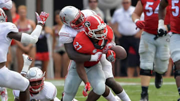 Sep 10, 2016; Athens, GA, USA; Nicholls State Colonels defensive lineman Kenny Dotson (97) hits Georgia Bulldogs running back Nick Chubb (27) causing a fumble during the second quarter at Sanford Stadium. Mandatory Credit: Dale Zanine-USA TODAY Sports