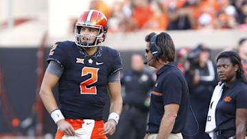 Oct 8, 2016; Stillwater, OK, USA; Oklahoma State Cowboys quarterback Mason Rudolph (2) talks with head coach Mike Gundy before a play against the Iowa State Cyclones during the second half at Boone Pickens Stadium. Oklahoma State won 38-31. Mandatory Credit: Alonzo Adams-USA TODAY Sports