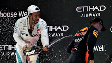 ABU DHABI, UNITED ARAB EMIRATES - NOVEMBER 25: Race winner Lewis Hamilton of Great Britain and Mercedes GP celebrates with third place Max Verstappen of Netherlands and Red Bull Racing on the podium during the Abu Dhabi Formula One Grand Prix at Yas Marina Circuit on November 25, 2018 in Abu Dhabi, United Arab Emirates. (Photo by Lars Baron/Getty Images)