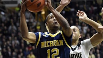 Jan 7, 2016; West Lafayette, IN, USA; Michigan Wolverines guard Muhammad-Ali Abdur-Rahkman (12) drives to the basket past Purdue Boilermakers guard Kendall Stephens (21) in the first half at Mackey Arena. Mandatory Credit: Sandra Dukes-USA TODAY Sports