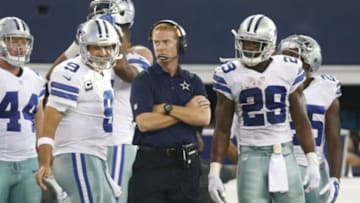 Oct 19, 2014; Arlington, TX, USA; Dallas Cowboys quarterback Tony Romo (9), head coach Jason Garrett and running back DeMarco Murray (29) on the sidelines in the fourth quarter against the New York Giants at AT&T Stadium. Murray broke the NFL record with 7+ consecutive games with 100+ yards. Dallas beat New York 31-21. Mandatory Credit: Tim Heitman-USA TODAY Sports
