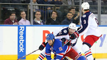 Feb 29, 2016; New York, NY, USA; New York Rangers left wing Tanner Glass (15) is pushed to the ice by Columbus Blue Jackets defenseman Fedor Tyutin (51) in front of Columbus Blue Jackets center Gregory Campbell (9) during the second period at Madison Square Garden. Mandatory Credit: Brad Penner-USA TODAY Sports