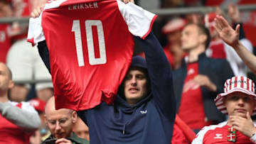 TOPSHOT - A Denmark fan holds up Denmark's midfielder Christian Eriksen's jersey during the UEFA EURO 2020 Group B football match between Denmark and Finland at the Parken Stadium in Copenhagen on June 12, 2021. (Photo by Jonathan NACKSTRAND / POOL / AFP) (Photo by JONATHAN NACKSTRAND/POOL/AFP via Getty Images)