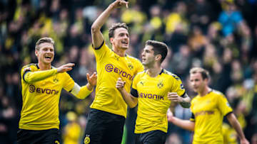 DORTMUND, GERMANY - MAY 11: (EDITORS NOTE: Image has been digitally enhanced.) Scorer Christian Pulisic (2R) of Dortmund celebrates his team's first goal with Thomas Delaney (2L) and Lukasz Piszczek (L) of Dortmund during the Bundesliga match between Borussia Dortmund and Fortuna Düsseldorf at Signal Iduna Park on May 11, 2019 in Dortmund, Germany. (Photo by Lukas Schulze/Bundesliga/DFL via Getty Images)