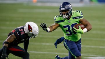 Nov 19, 2020; Seattle, Washington, USA; Seattle Seahawks running back Carlos Hyde (30) runs the ball against Arizona Cardinals safety Budda Baker (32) during the first quarter at Lumen Field. Mandatory Credit: Joe Nicholson-USA TODAY Sports