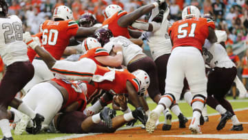 MIAMI, FLORIDA - SEPTEMBER 14: DeeJay Dallas #13 of the Miami Hurricanes dives into the end zone for a touchdown against the Bethune Cookman Wildcats during the first half at Hard Rock Stadium on September 14, 2019 in Miami, Florida. (Photo by Michael Reaves/Getty Images)