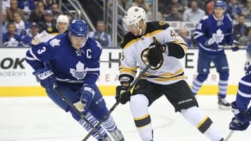 Oct 25, 2014; Toronto, Ontario, CAN; Boston Bruins center David Krejci (46) controls the puck as Toronto Maple Leafs defenseman Dion Phaneuf (3) bears down on him at Air Canada Centre. Mandatory Credit: Tom Szczerbowski-USA TODAY Sports