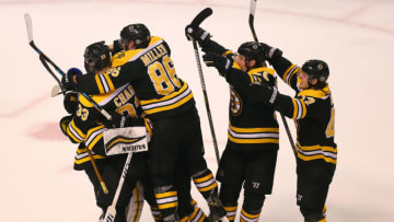 BOSTON, MA - APRIL 25: Boston Bruins players mob goalie Tuukka Rask at the end of the game. The Boston Bruins host the Toronto Maple Leafs in Game Seven of the Eastern Conference First Round during the 2018 NHL Stanley Cup Playoffs at the TD Garden in Boston on April 25, 2018. (Photo by John Tlumacki/The Boston Globe via Getty Images)