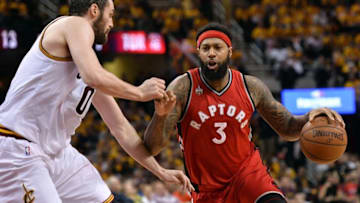 May 19, 2016; Cleveland, OH, USA; Toronto Raptors forward James Johnson (3) dribbles the ball as Cleveland Cavaliers forward Kevin Love (0) defends during the second quarter in game two of the Eastern conference finals of the NBA Playoffs at Quicken Loans Arena. Mandatory Credit: Ken Blaze-USA TODAY Sports