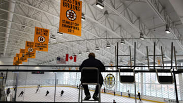 BOSTON - FEBRUARY 8: A lone fan sits in the stands with Stanley Cup banners hanging above as the Boston Bruins practice at Warrior Arena with new coach Bruce Cassidy on Feb. 8, 2017. (Photo by John Tlumacki/The Boston Globe via Getty Images)