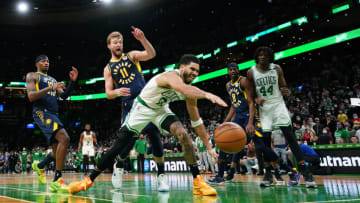 Jan 10, 2022; Boston, Massachusetts, USA; Boston Celtics forward Jayson Tatum (0) works for the loose ball against Indiana Pacers forward Domantas Sabonis (11) in overtime at TD Garden. Mandatory Credit: David Butler II-USA TODAY Sports