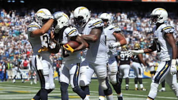 Sep 18, 2016; San Diego, CA, USA; San Diego Chargers wide receiver Travis Benjamin (12) is congratulated after scoring a touchdown by teammates fullback Derek Watt (34) and offensive guard Orlando Franklin (74) during the first quarter of the game against the Jacksonville Jaguars at Qualcomm Stadium. Mandatory Credit: Orlando Ramirez-USA TODAY Sports