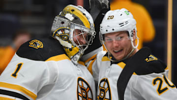 Dec 2, 2021; Nashville, Tennessee, USA; Boston Bruins goaltender Jeremy Swayman (1) and Boston Bruins center Curtis Lazar (20) celebrate after a shutout win against the Nashville Predators at Bridgestone Arena. Mandatory Credit: Christopher Hanewinckel-USA TODAY Sports
