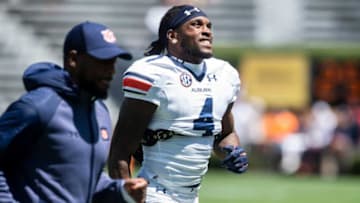 Auburn football running backs coach Carnell Williams and Auburn Tigers running back Tank Bigsby (4) run off the field following warm ups during the A-Day spring practice at Jordan-Hare Stadium in Auburn, Ala., on Saturday, April 9, 2022.