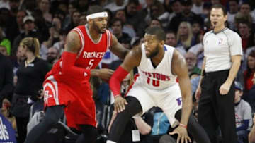 Jan 31, 2015; Auburn Hills, MI, USA; Detroit Pistons forward Greg Monroe (10) defended by Houston Rockets forward Josh Smith (5) during the first quarter at The Palace of Auburn Hills. Mandatory Credit: Raj Mehta-USA TODAY Sports