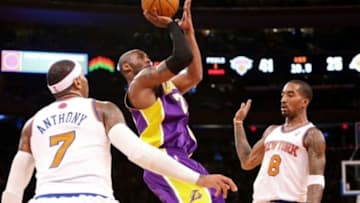 Dec. 13, 2012; New York, NY, USA; Los Angeles Lakers shooting guard Kobe Bryant (24) shoots between New York Knicks small forward Carmelo Anthony (7) and shooting guard J.R. Smith (8) during the first half at Madison Square Garden. Mandatory Credit: Debby Wong-USA TODAY Sports