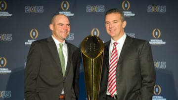 Jan 11, 2015; Arlington, TX, USA; Oregon Ducks head coach Mark Helfrich (left) and Ohio State Buckeyes head coach Urban Meyer pose with the championship trophy during a press conference at the Renaissance Dallas Hotel. Mandatory Credit: Jerome Miron-USA TODAY Sports
