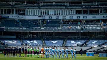 NEW YORK, NY - APRIL 24: Members of New York City FC and FC Cincinnati stand for a moment of silence for those that have been lost to the Corona Virus before the start of the home opener match at Yankee Stadium on April 24, 2021 in New York City. (Photo by Ira L. Black - Corbis/Getty Images)