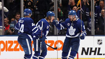 Kasperi Kapanen #24 of the Toronto Maple Leafs (C) celebrates his third period goal against the Boston Bruins and is joined by Morgan Rielly #44 (L) and Zach Hyman #11 (R) at the Scotiabank Arena. (Photo by Bruce Bennett/Getty Images)