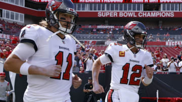 TAMPA, FLORIDA - SEPTEMBER 19: Quarterbacks Blaine Gabbert #11 and Tom Brady #12 of the Tampa Bay Buccaneers jog onto the field before the game against the Atlanta Falcons at Raymond James Stadium on September 19, 2021 in Tampa, Florida. (Photo by Douglas P. DeFelice/Getty Images)