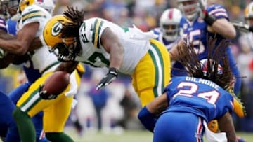 Dec 14, 2014; Orchard Park, NY, USA; Green Bay Packers running back Eddie Lacy (27) attempts to avoid a tackle by Buffalo Bills cornerback Stephon Gilmore (24) during the first half at Ralph Wilson Stadium. Mandatory Credit: Timothy T. Ludwig-USA TODAY Sports