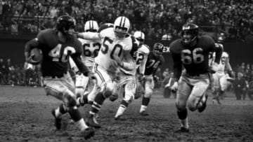 NEW YORK - DECEMBER 5, 1960: Runningback Joe Morrison #40 of the New York Giants looks for a block from lineman Jack Stroud #66 on linebacker Jerry Tubbs #50 of the Dallas Cowboys during a game on December 5, 1960 against the Dallas Cowboys at Yankee Stadium in New York, New York. 601205-01 (Photo by: Kidwiler Collection/Diamond Images/Getty Images)