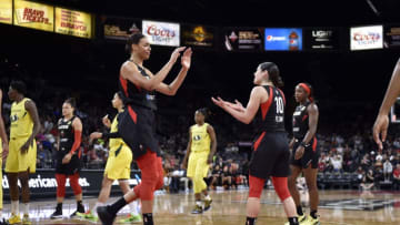 LAS VEGAS, NV - JUNE 25: Liz Cambage #8 and Kelsey Plum #10 of the Las Vegas Aces high five during the game against the Seattle Storm on June 25, 2019 at the Mandalay Bay Events Center in Las Vegas, Nevada. NOTE TO USER: User expressly acknowledges and agrees that, by downloading and/or using this photograph, user is consenting to the terms and conditions of the Getty Images License Agreement. Mandatory Copyright Notice: Copyright 2019 NBAE (Photo by David Becker/NBAE via Getty Images)