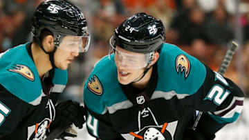 ANAHEIM, CALIFORNIA - DECEMBER 31: Brandon Montour #26 of the Anaheim Ducks and Carter Rowney #24 of the Anaheim Ducks talk during the second period against the Tampa Bay Lightning at Honda Center on December 31, 2018 in Anaheim, California. (Photo by Katharine Lotze/Getty Images)