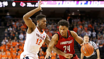 CHARLOTTESVILLE, VA - MARCH 09: Dwayne Sutton #24 of the Louisville Cardinals drives past De'Andre Hunter #12 of the Virginia Cavaliers in the first half during a game at John Paul Jones Arena on March 9, 2019 in Charlottesville, Virginia. (Photo by Ryan M. Kelly/Getty Images)