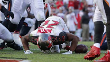 Nov 13, 2016; Tampa, FL, USA; Tampa Bay Buccaneers running back Doug Martin (22) kisses the field after he ran the ball in for a touchdown against the Chicago Bears during the second half at Raymond James Stadium. Tampa Bay Buccaneers defeated the Chicago Bears 36-10. Mandatory Credit: Kim Klement-USA TODAY Sports