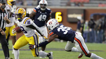 Auburn footballOct 31, 2020; Auburn, Alabama, USA; LSU Tigers running back Chris Curry (18) is tackled by Auburn Tigers linebacker Cam Riley (35) during the fourth quarter at Jordan-Hare Stadium. Mandatory Credit: John Reed-USA TODAY Sports