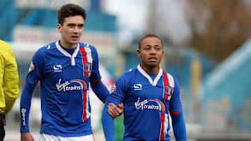 CARLISLE, ENGLAND - MARCH 05: Alex Gilliead and Derek Asamoah of Carlisle United line up to defend a free kick during the Sky Bet League Two match between Carlisle United and Northampton Town at Brunton Park on March 5, 2016 in Carlisle, England. (Photo by Pete Norton/Getty Images)