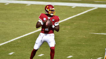 Oct 4, 2020; Landover, Maryland, USA; Washington Football Team quarterback Dwayne Haskins (7) attempts a pass against the Baltimore Ravens during the first quarter at FedExField. Mandatory Credit: Brad Mills-USA TODAY Sports